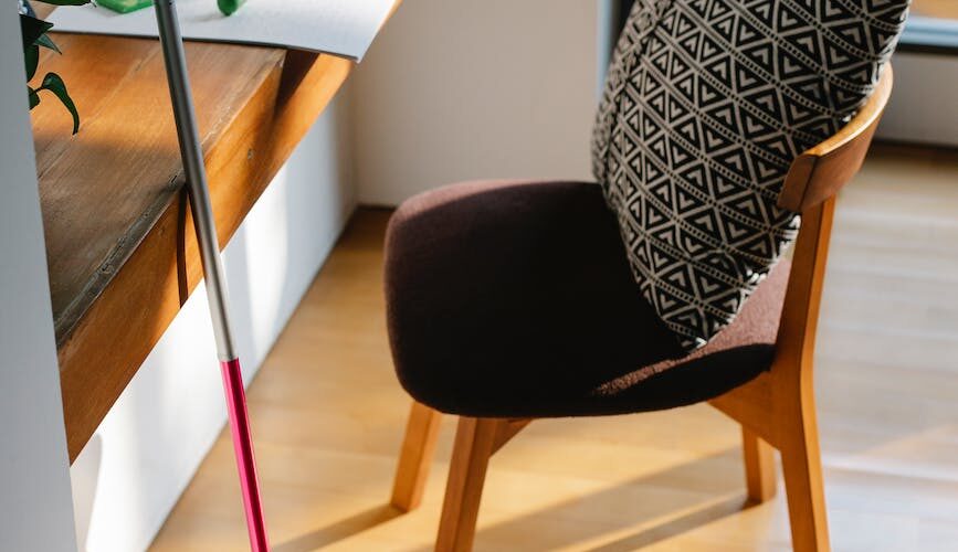 photo of wooden desk and wooden chair in a room